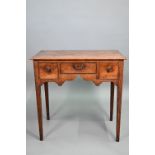 An 18th century oak three drawer side table raised on square section legs