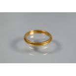 A 22ct yellow gold wedding band with engraved edge, size M, approx 3.2g