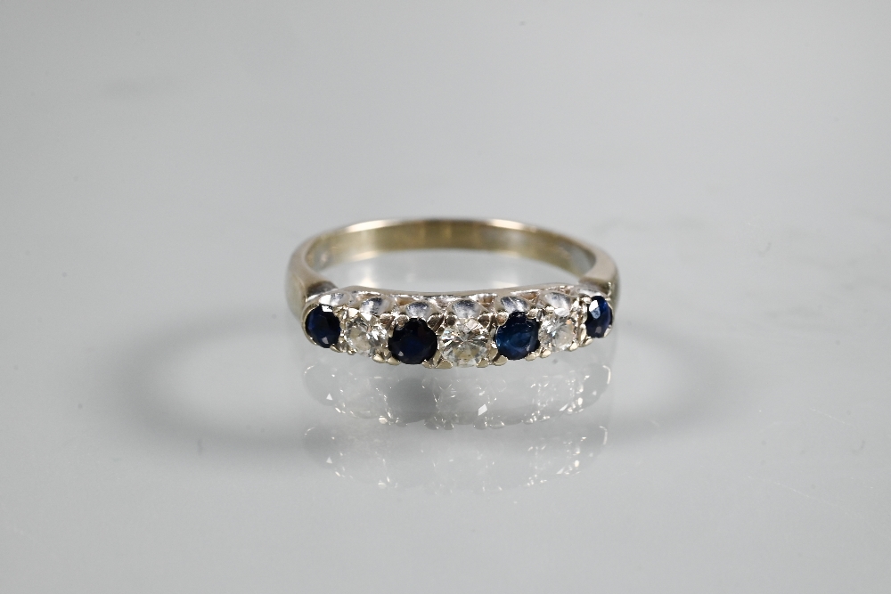 A seven stone ring, the alternate circular dark blue sapphires and diamonds in white metal setting - Image 2 of 3