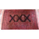 An old Belouch rug, the brown-red ground with stylised lozenge guls, 214 cm x 140 cm