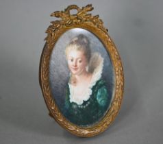 An early 20th century oval portrait miniature on ivory of a young lady in 17th century costume,