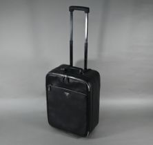 A Prada carry-on suitcase, with wheels and trolley-handle, nylon and Saffiano leather exterior,