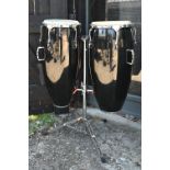 A good pair of conga drums, with central stand, each drum 75 cm high