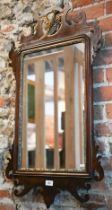 A Georgian style mahogany and gilt framed fret cut mirror, surmounted by a ho-ho bird, 91 cm x 50 cm