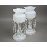 A good quality pair of 19th century milk glass lustres, on raised circular bases, each with a