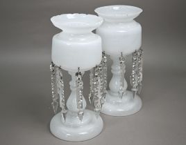 A good quality pair of 19th century milk glass lustres, on raised circular bases, each with a