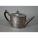 A George III silver tea pot of oval form with straight spout, nail-punch decoration and ebonised