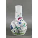 A 19th century Chinese famille rose bottle vase, painted in polychrome enamels with a tall prunus