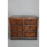 A rustic late 17th/18th century joined oak framed six drawer chest, raised on stile feet, probably