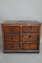 A rustic late 17th/18th century joined oak framed six drawer chest, raised on stile feet, probably