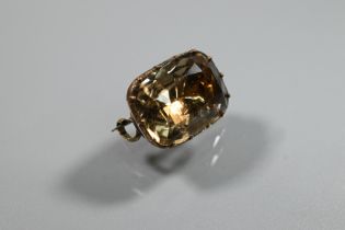A Georgian foil back brooch set with a cushion-cut rock crystal, the unmarked yellow metal brooch