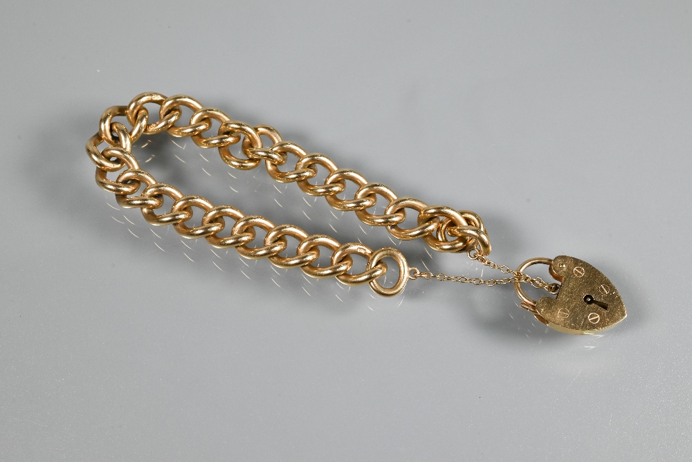 A 9ct yellow gold curb bracelet with padlock and safety chain attached, approx 42.7g