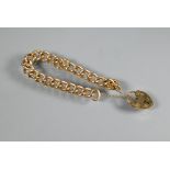 A 9ct yellow gold curb bracelet with padlock and safety chain attached, approx 42.7g