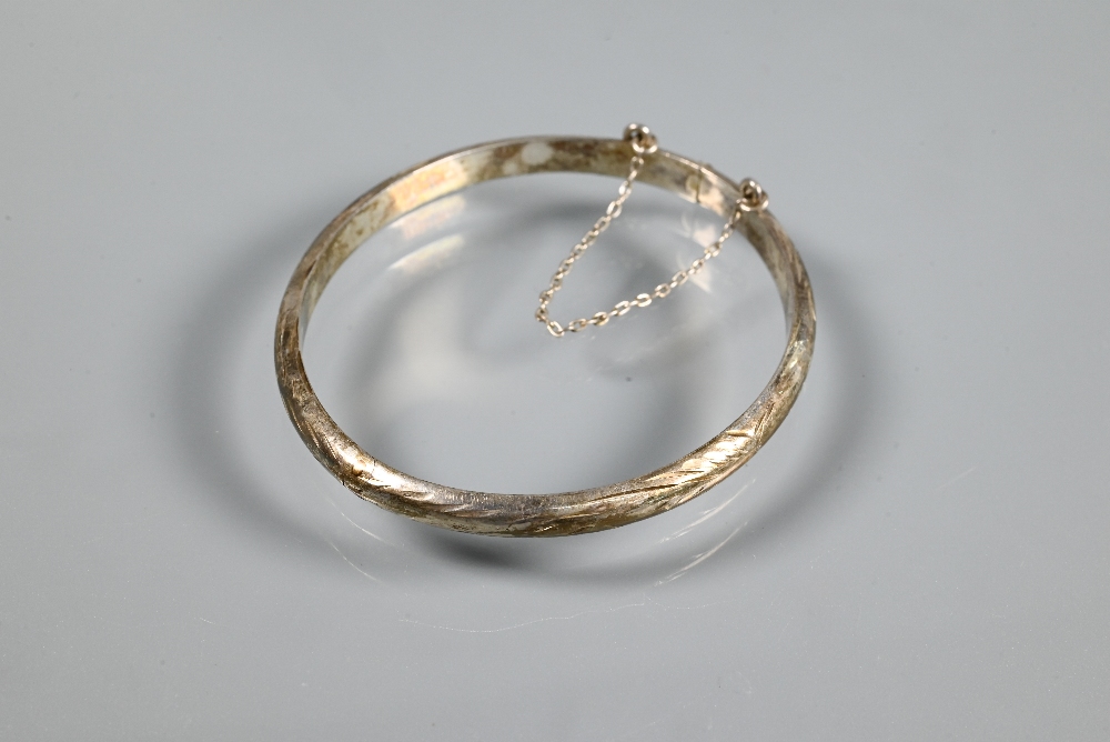 A wide white metal oval half-hinged bangle with engraved floral decoration to front, stamped ' - Image 5 of 5