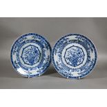 A pair of 18th century Chinese blue and white plates painted with floral design in tones of