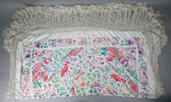 A Chinese sik piano shawl, the cream ground profusely embroidered with figures, Pagoda scenes and