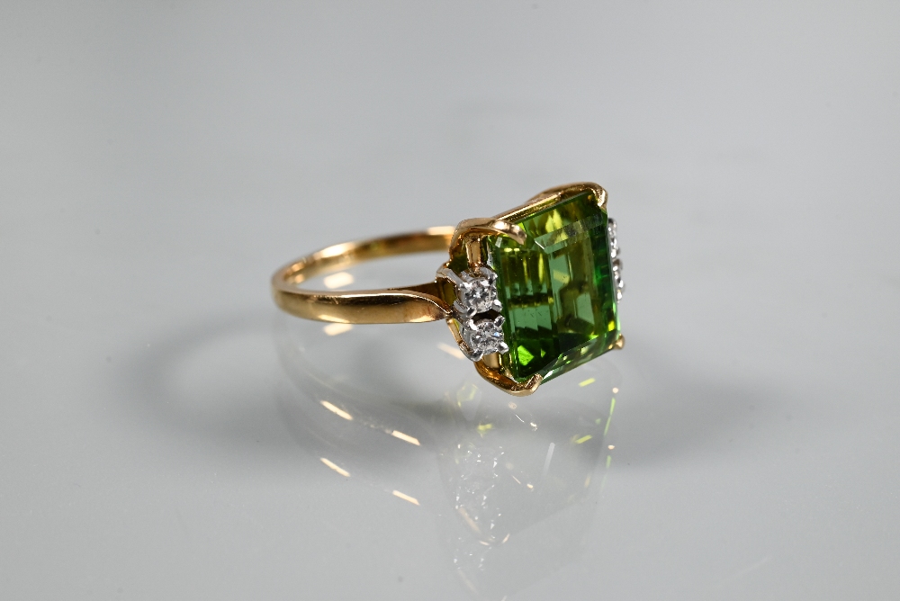 A ring, the square cut green tourmaline with two diamonds to each shoulder, yellow and white metal