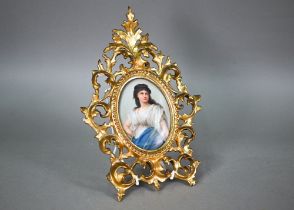 A German porcelain oval plaque painted with Medea after Sichel, 12 x 9 cm, in ornate giltwood