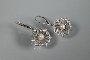 A pair of drop earrings for pierced ears, the open daisy cluster with pearl to the centre and