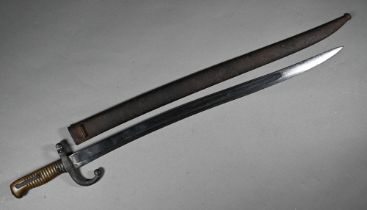 A French 1868 St Etienne pattern bayonet with 57 cm recurved and fullered blade and brass hilt, in