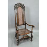 A William & Mary oak framed cane panelled armchair, with moulded frame, scroll arm ends and front