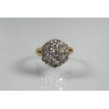 A diamond cluster ring, the central daisy cluster with border around, 18ct yellow and white gold