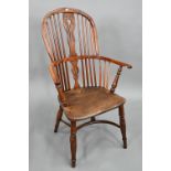 An antique yew and elm Windsor high splat-back armchair, Lincolnshire, with crinoline stretcher