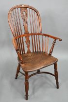 An antique yew and elm Windsor high splat-back armchair, Lincolnshire, with crinoline stretcher