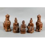 A pair of South East Asian carved hardwood Buddhistic guardian lions, 15 cm high to/w a pair of
