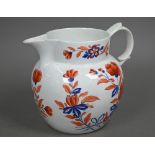 An early 19th century stoneware large jug with floral painted decoration in iron red and blue