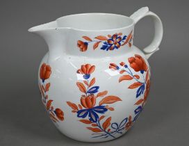 An early 19th century stoneware large jug with floral painted decoration in iron red and blue