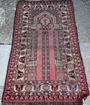 An antique Caucasian Red ground prayer rug, the geometric deign on crimson ground, 166 cm x 95 cm