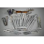 A collection of silver-handled button-hooks, to/w tea knives, nail-buffers, matchbox covers, etc.