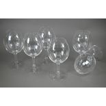 A set of six large and good quality wine-glasses, etched with gryphon crests, on octagonal-cut