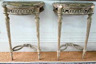 A pair of antique continental carved lime wood demi-lune console tables, the (loose) tops with