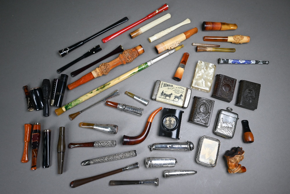 A collection of cheroot/cigarette holders including a 'Jazz Age' telescopic example extending to 104
