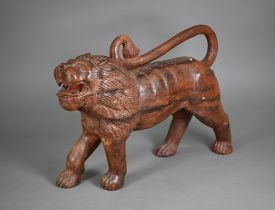 A mid-century hand carved weathered Asiatic lion, 50 cm long, 14 cm wide, 36 cm high