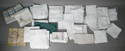 Box of assorted textiles including embroidered tablewares, doilies, dark green table cloths and