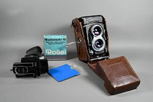 A Rolleiflex twin-lens reflex camera with Synchro-Compur lens, in leather case with trigger-