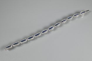 An 18ct white gold Art Deco style sapphire and diamond set bracelet formed of oval links with five