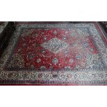 An old Persian mahal carpet, the pale red ground centred by a stylised floral medallion, 377 cm x