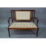 An Edwardian Sheraton Revival satinwood framed sofa, with fabric back panel and seat, raised on