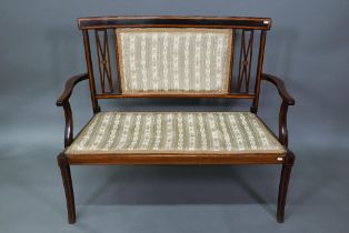 An Edwardian Sheraton Revival satinwood framed sofa, with fabric back panel and seat, raised on