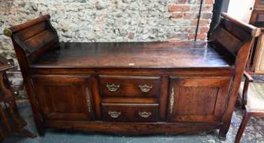 An 18th century oak low dresser / sideboard, of unusual form, the top with raised gallery ends