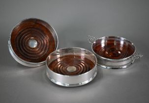 A pair of silver wine coasters, the turned bases inset with silver buttons, David R. Mills, London