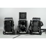 Three Mamiya C330 twin-lens reflex cameras with accessories