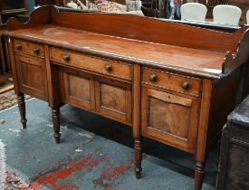 A Victorian mahogany 3/4 galleried sideboard, with an arrangement of three drawers and centred by