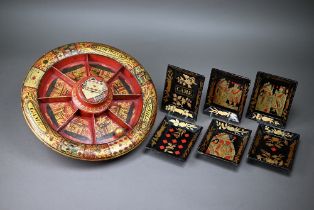 19th century papier maché 'Pope Joan' game, with revolving segmented bowl, gilt decorated on a red