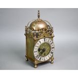 A small traditional brass Smiths lantern style clock, with Roman Numeral engraved silvered dial, the