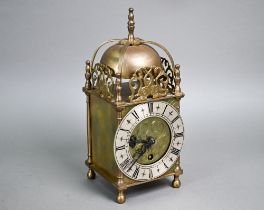 A small traditional brass Smiths lantern style clock, with Roman Numeral engraved silvered dial, the